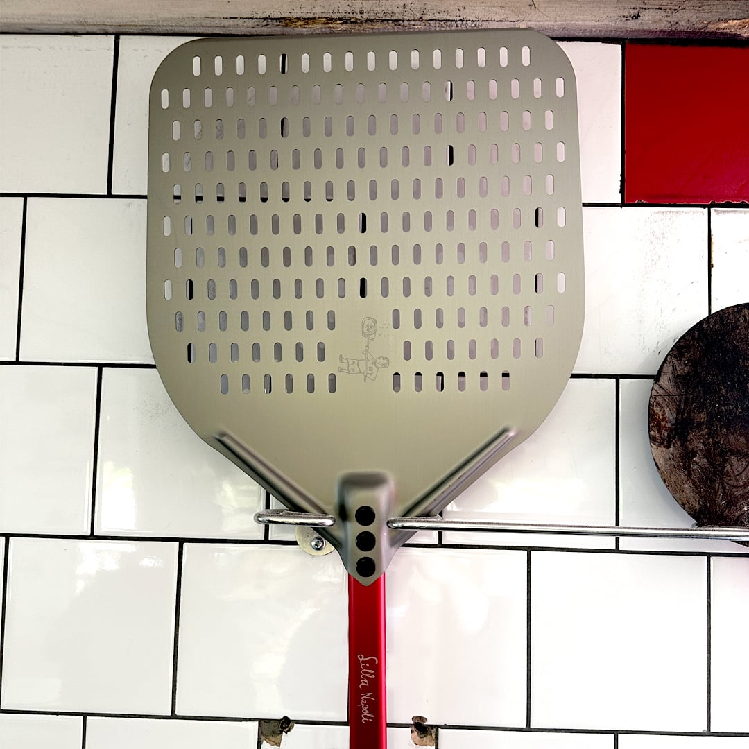 Wall holder for pizza peels